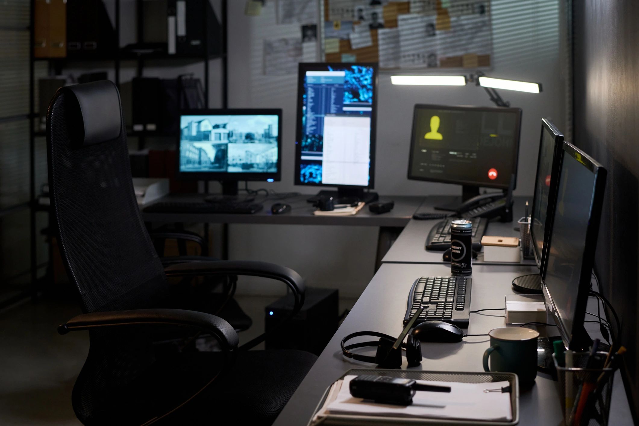 Security operations desk with multiple monitoring screens